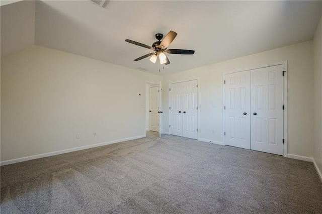 unfurnished bedroom featuring ceiling fan, carpet flooring, two closets, and baseboards