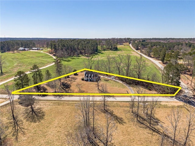 bird's eye view featuring a wooded view