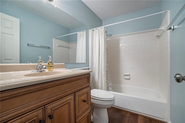 full bathroom featuring toilet, wood-type flooring, a textured ceiling, vanity, and shower / bath combo