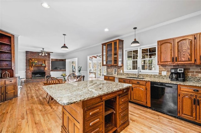 kitchen featuring dishwasher, pendant lighting, backsplash, and a sink