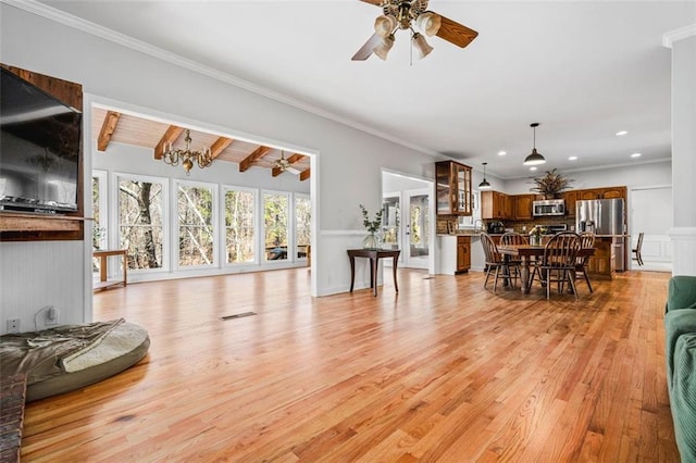 living area with crown molding, beam ceiling, recessed lighting, ceiling fan with notable chandelier, and light wood-style floors