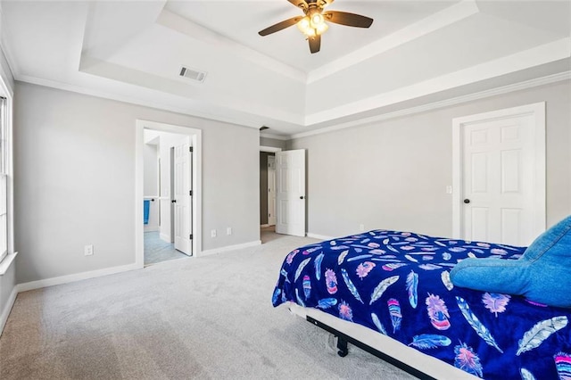 carpeted bedroom with visible vents, a ceiling fan, baseboards, crown molding, and a raised ceiling