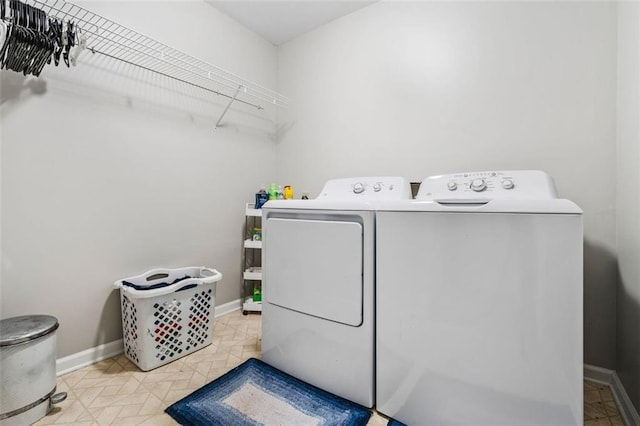 laundry room with baseboards, washing machine and dryer, and laundry area