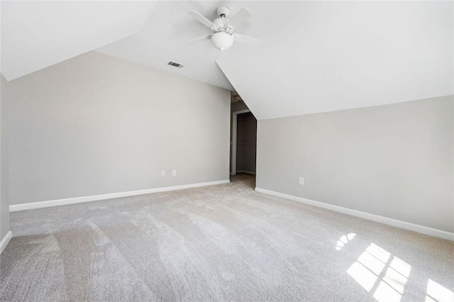 additional living space with visible vents, ceiling fan, baseboards, and lofted ceiling