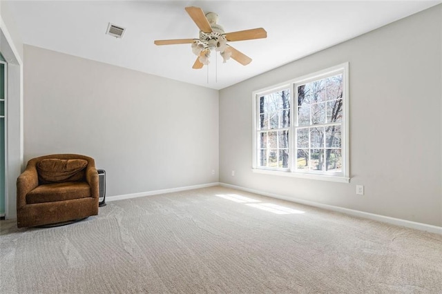 living area featuring visible vents, a ceiling fan, baseboards, and carpet floors