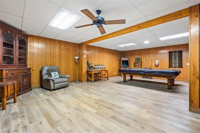 rec room with billiards, wooden walls, wood finished floors, a drop ceiling, and ceiling fan