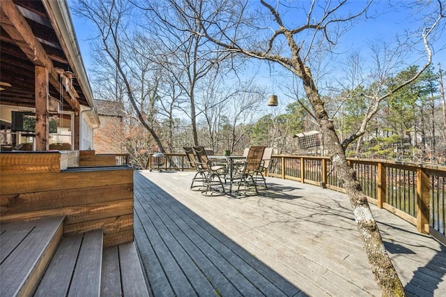 wooden terrace with outdoor dining space