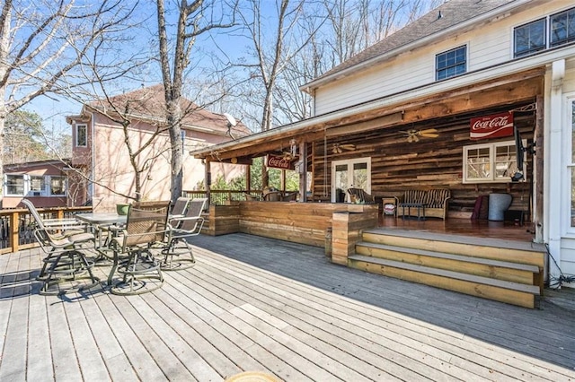 wooden deck featuring french doors and outdoor dining area