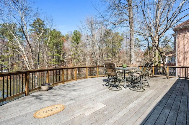 wooden terrace with outdoor dining area