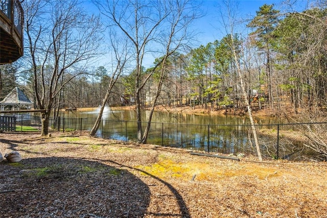 view of yard with fence and a water view