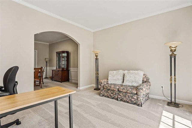 office space with a wainscoted wall, ornamental molding, arched walkways, carpet, and baseboards