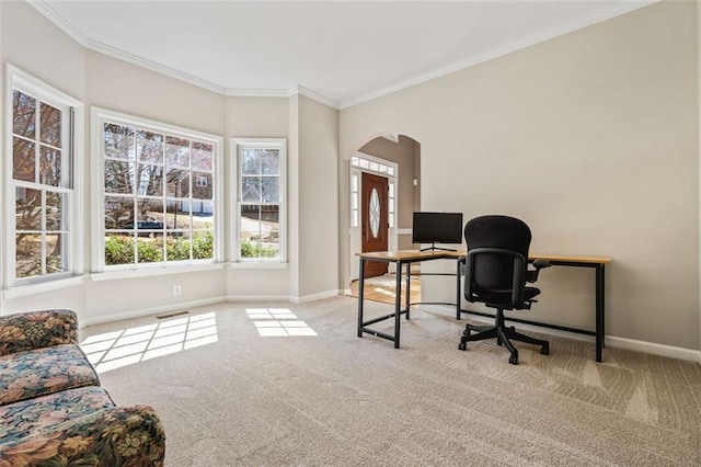 office featuring arched walkways, visible vents, a wealth of natural light, and carpet