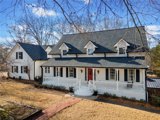 view of front of property with roof with shingles and covered porch