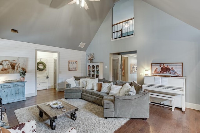 living room featuring ceiling fan, dark wood-type flooring, and high vaulted ceiling