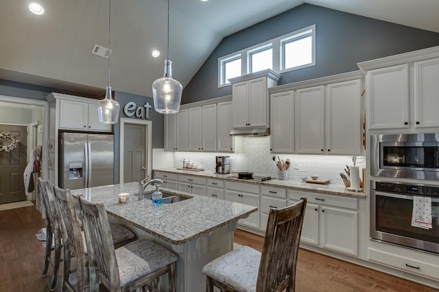 kitchen featuring white cabinets, tasteful backsplash, appliances with stainless steel finishes, and dark hardwood / wood-style flooring