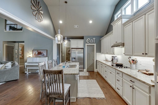 kitchen with backsplash, dark wood-type flooring, high vaulted ceiling, and high end refrigerator