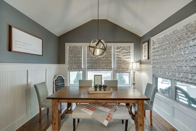 dining room featuring lofted ceiling and hardwood / wood-style flooring