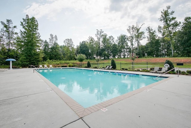 view of pool with a lawn and a patio area