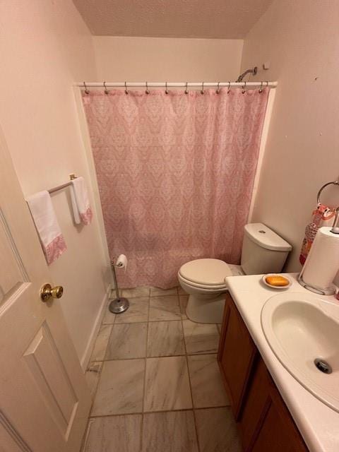 bathroom featuring toilet, curtained shower, and vanity