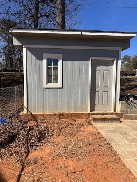 view of outdoor structure with an outbuilding and fence