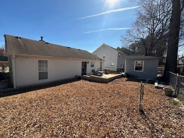 rear view of house with fence