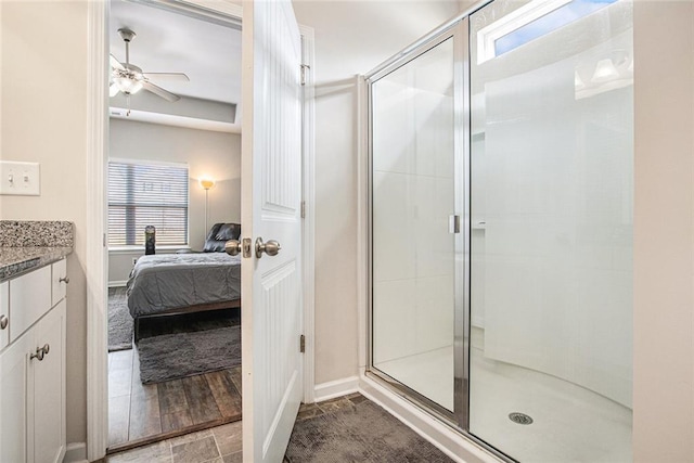 ensuite bathroom featuring ensuite bath, a shower stall, a ceiling fan, and vanity