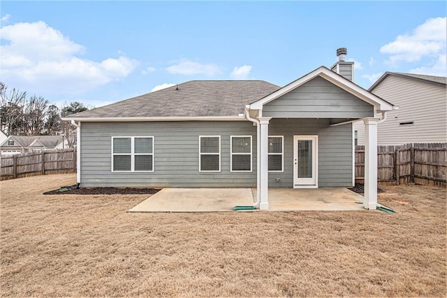 rear view of property with a fenced backyard, a patio, and a lawn