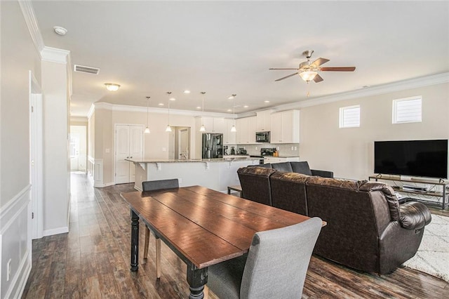 dining area featuring visible vents, dark wood finished floors, a ceiling fan, ornamental molding, and recessed lighting