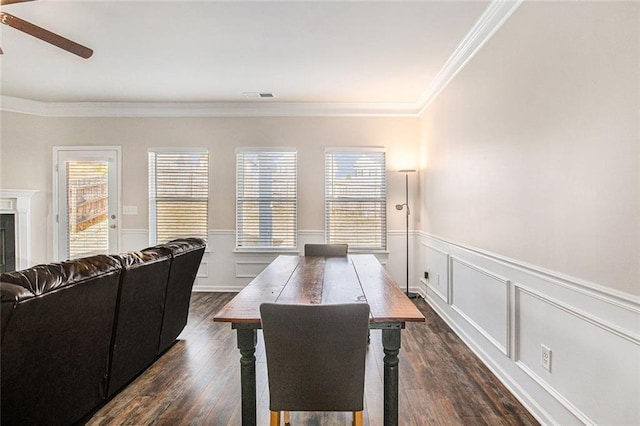 dining area featuring visible vents, a ceiling fan, ornamental molding, dark wood-type flooring, and a fireplace