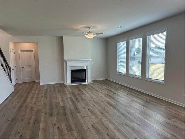 57 Longhorn Way, Auburn, GA 30011 - unfurnished living room with a ceiling fan, stairs, a fireplace, and wood finished floors