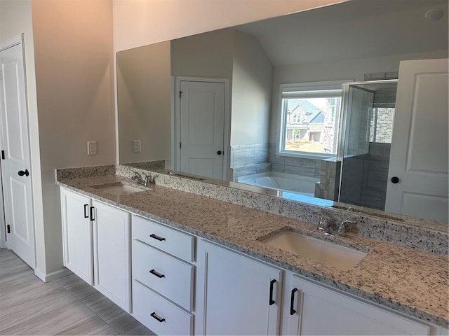 57 Longhorn Way, Auburn, GA 30011 - full bath with double vanity, a bath, a shower stall, vaulted ceiling, and baseboards