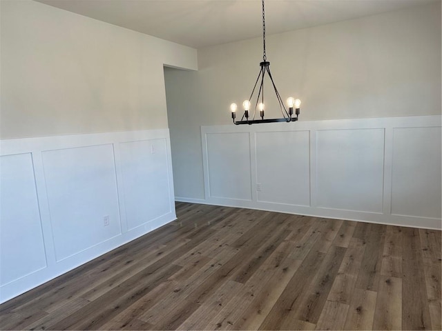 57 Longhorn Way, Auburn, GA 30011 - unfurnished dining area with a decorative wall, a chandelier, wainscoting, and wood finished floors