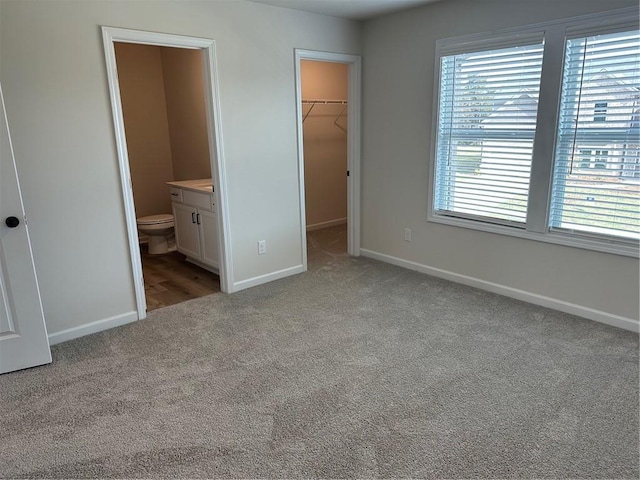 57 Longhorn Way, Auburn, GA 30011 - unfurnished bedroom with carpet, a spacious closet, baseboards, a closet, and ensuite bathroom