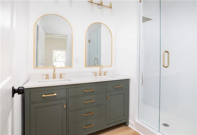 bathroom with vanity and a shower with shower door