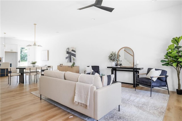 living room featuring ceiling fan and light hardwood / wood-style flooring