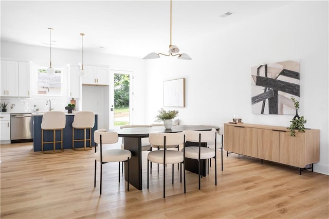 dining room featuring sink and light wood-type flooring