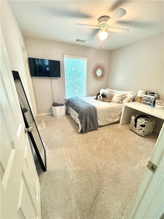 6725 Grove Meadows Ln, Cumming, GA 30028 - carpeted bedroom featuring a ceiling fan and baseboards