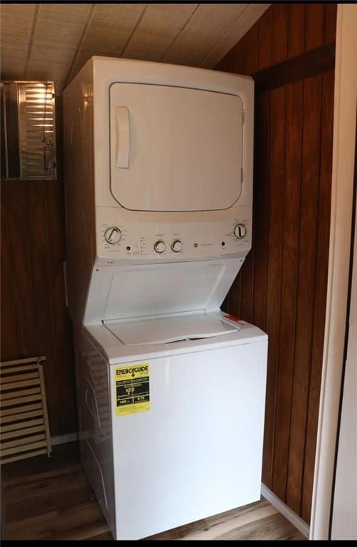 225 Overlook Cir, Clarkesville, GA 30523 - laundry area with stacked washer / drying machine, wooden walls, and wood finished floors