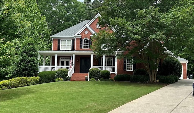 3256 Waterhouse St NW, Kennesaw, GA 30152 - view of front facade featuring a front lawn, covered porch, and brick siding