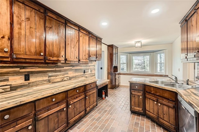 kitchen featuring a sink, light countertops, recessed lighting, brick floor, and stainless steel dishwasher