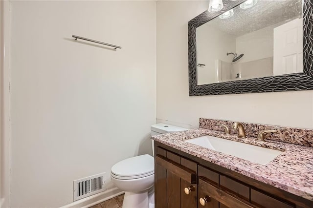 bathroom with vanity, visible vents, tile patterned flooring, a textured ceiling, and toilet