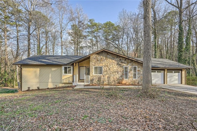 view of front facade with stone siding, concrete driveway, and an attached garage