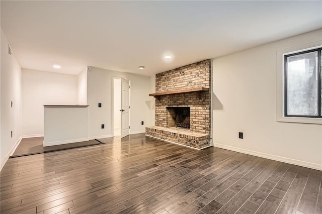 unfurnished living room featuring baseboards and wood finished floors