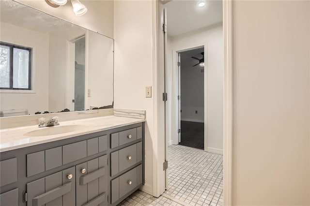 bathroom featuring tile patterned floors, baseboards, and vanity