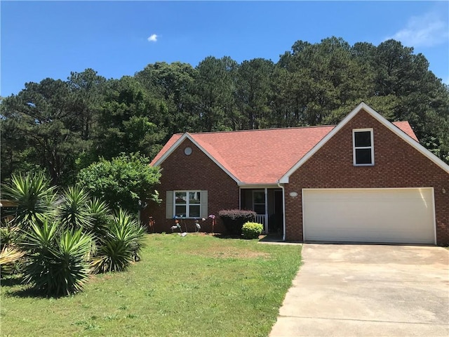 75 Oak Hill Dr, Covington, GA 30016 - view of front of home with a front lawn, concrete driveway, and brick siding