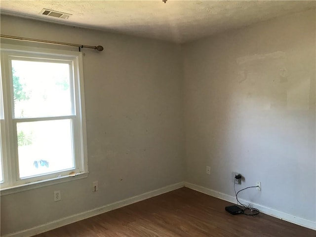 75 Oak Hill Dr, Covington, GA 30016 - spare room with plenty of natural light, dark wood-style flooring, and baseboards