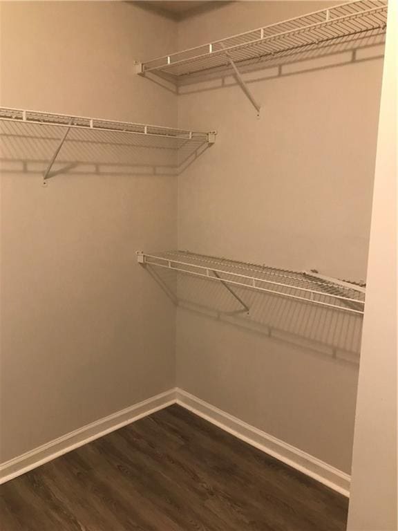 75 Oak Hill Dr, Covington, GA 30016 - spacious closet with dark wood-style flooring