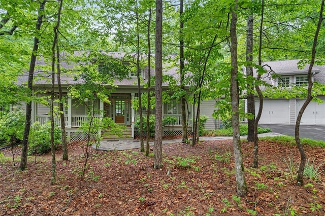 74 Cherokee Way, Big Canoe, GA 30143 - obstructed view of property with covered porch, a garage, and aphalt driveway