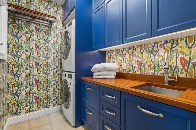 74 Cherokee Way, Big Canoe, GA 30143 - washroom with cabinet space, a sink, baseboards, light tile patterned floors, and stacked washer and clothes dryer