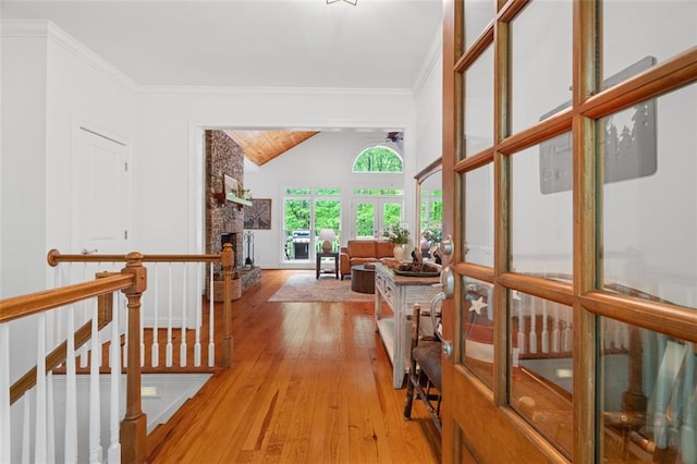74 Cherokee Way, Big Canoe, GA 30143 - hallway featuring an upstairs landing, ornamental molding, lofted ceiling, and light wood-type flooring